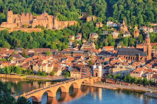 team-3 Panoramic view of Heidelberg with the historic old bridge and castle at sunset.